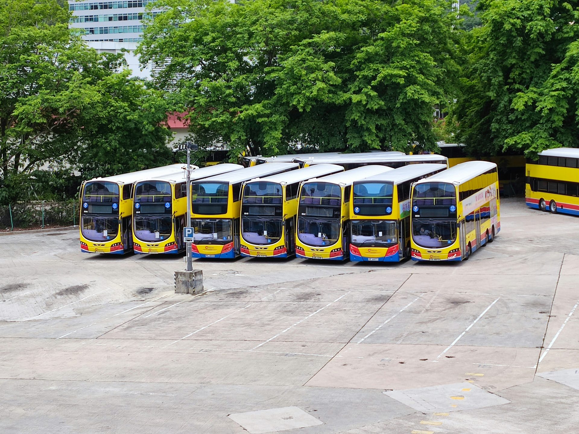 a group of buses parked in a parking lot